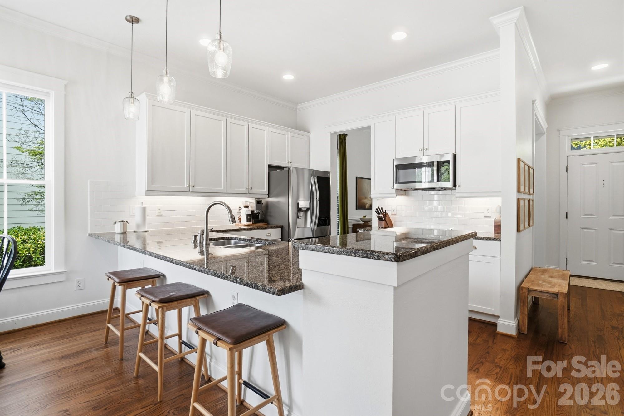 4333 Birkshire Heights Fort Mill, SC 29708 - Photo 11 of 48 a kitchen with granite countertop white cabinets and stainless steel appliances