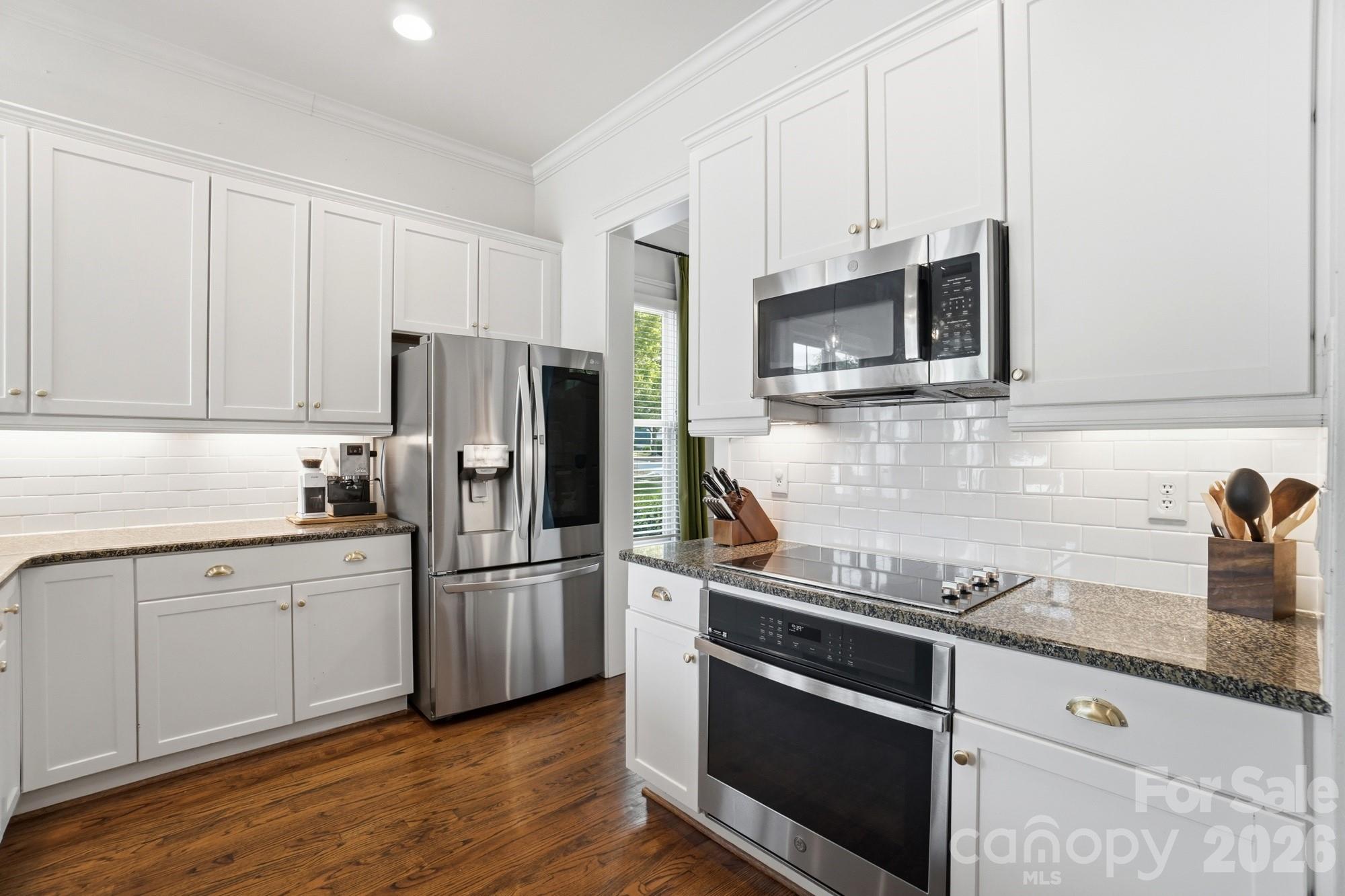 4333 Birkshire Heights Fort Mill, SC 29708 - Photo 13 of 48 a kitchen with granite countertop a refrigerator stove and microwave