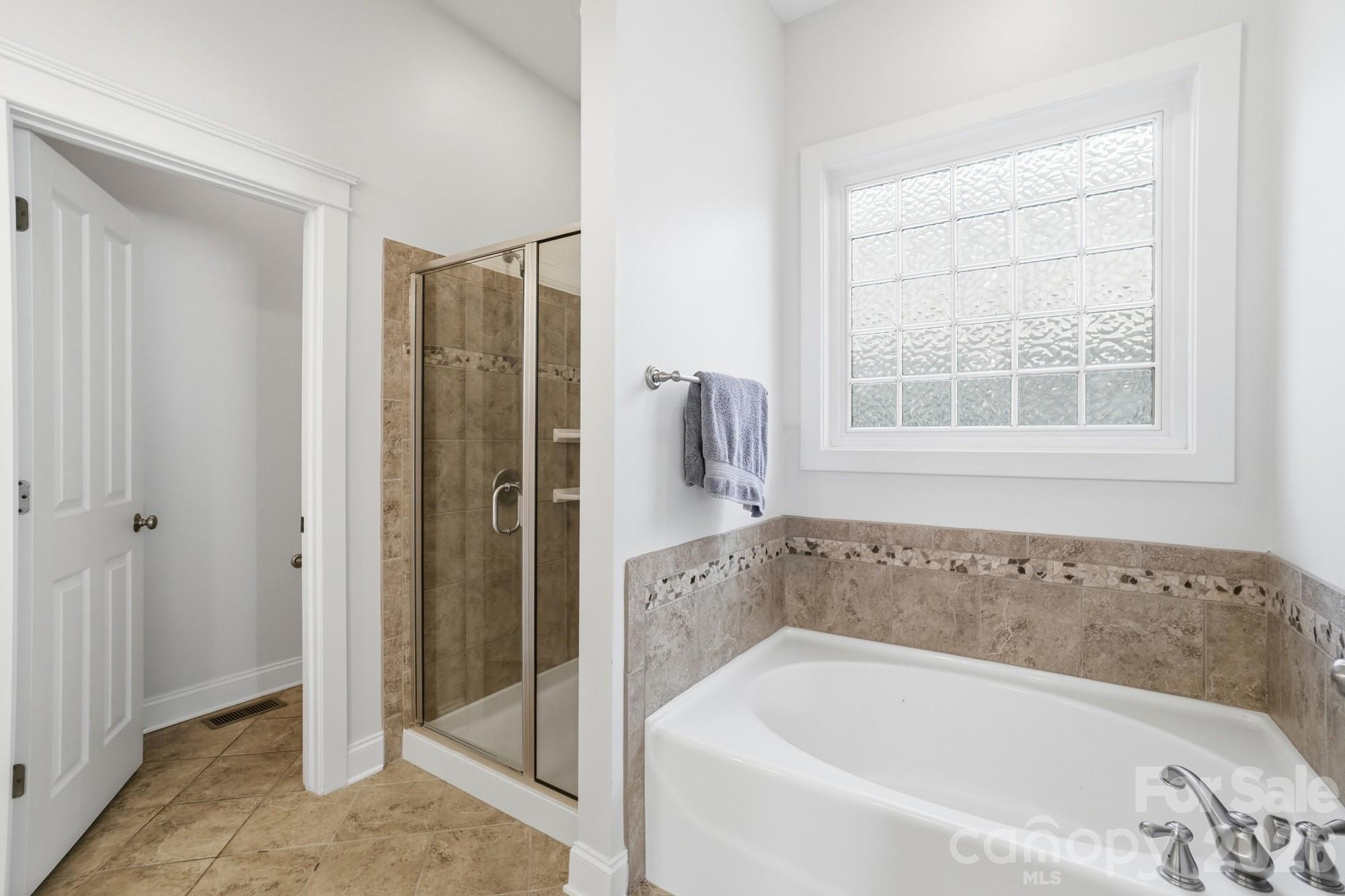 4333 Birkshire Heights Fort Mill, SC 29708 - Photo 22 of 48 a bathroom with a bathtub and a shower