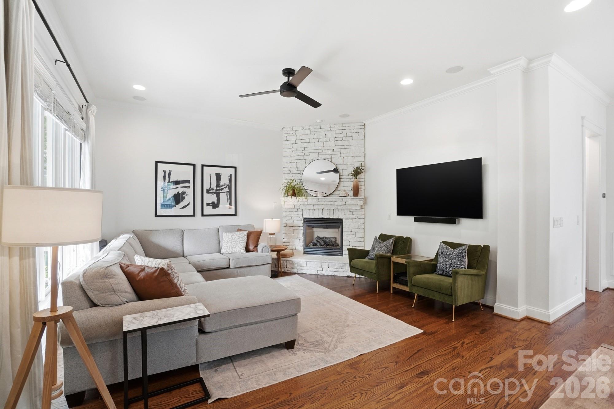 4333 Birkshire Heights Fort Mill, SC 29708 - Photo 5 of 48 a living room with furniture a flat screen tv and a fireplace