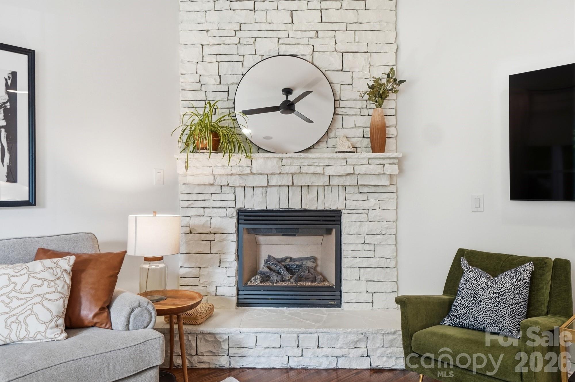 4333 Birkshire Heights Fort Mill, SC 29708 - Photo 9 of 48 a living room with furniture a fireplace and a flat screen tv
