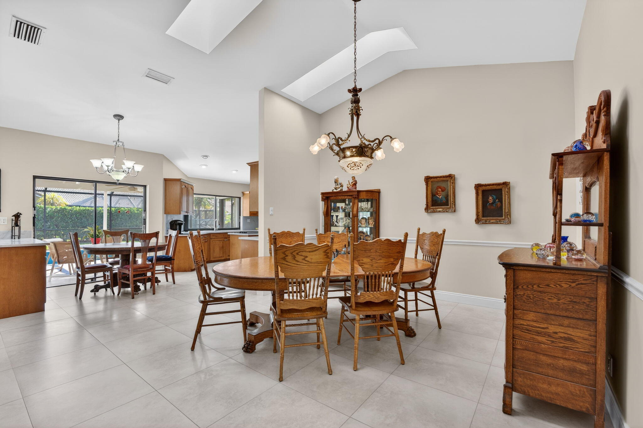5111 Northwest 85th Road Coral Springs, FL 33067 - Photo 11 of 47 a view of a dining room and livingroom with furniture wooden floor a chandelier