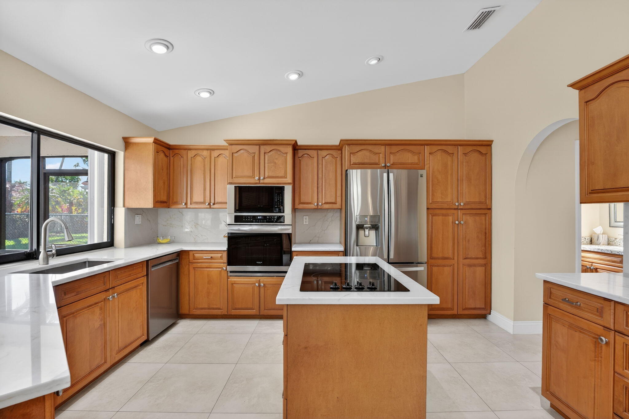 5111 Northwest 85th Road Coral Springs, FL 33067 - Photo 15 of 47 a kitchen with granite countertop a stove top oven sink and refrigerator