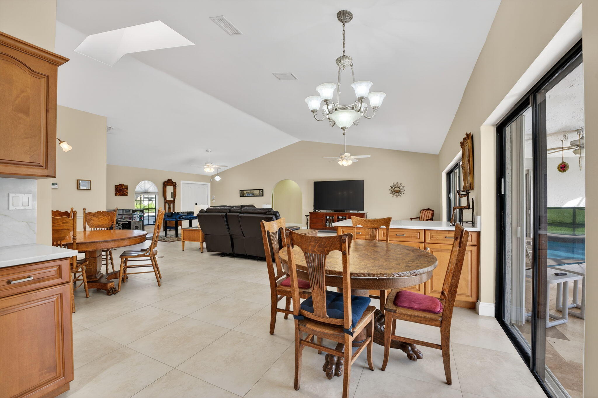 5111 Northwest 85th Road Coral Springs, FL 33067 - Photo 16 of 47 a view of a dining room with furniture and a chandelier