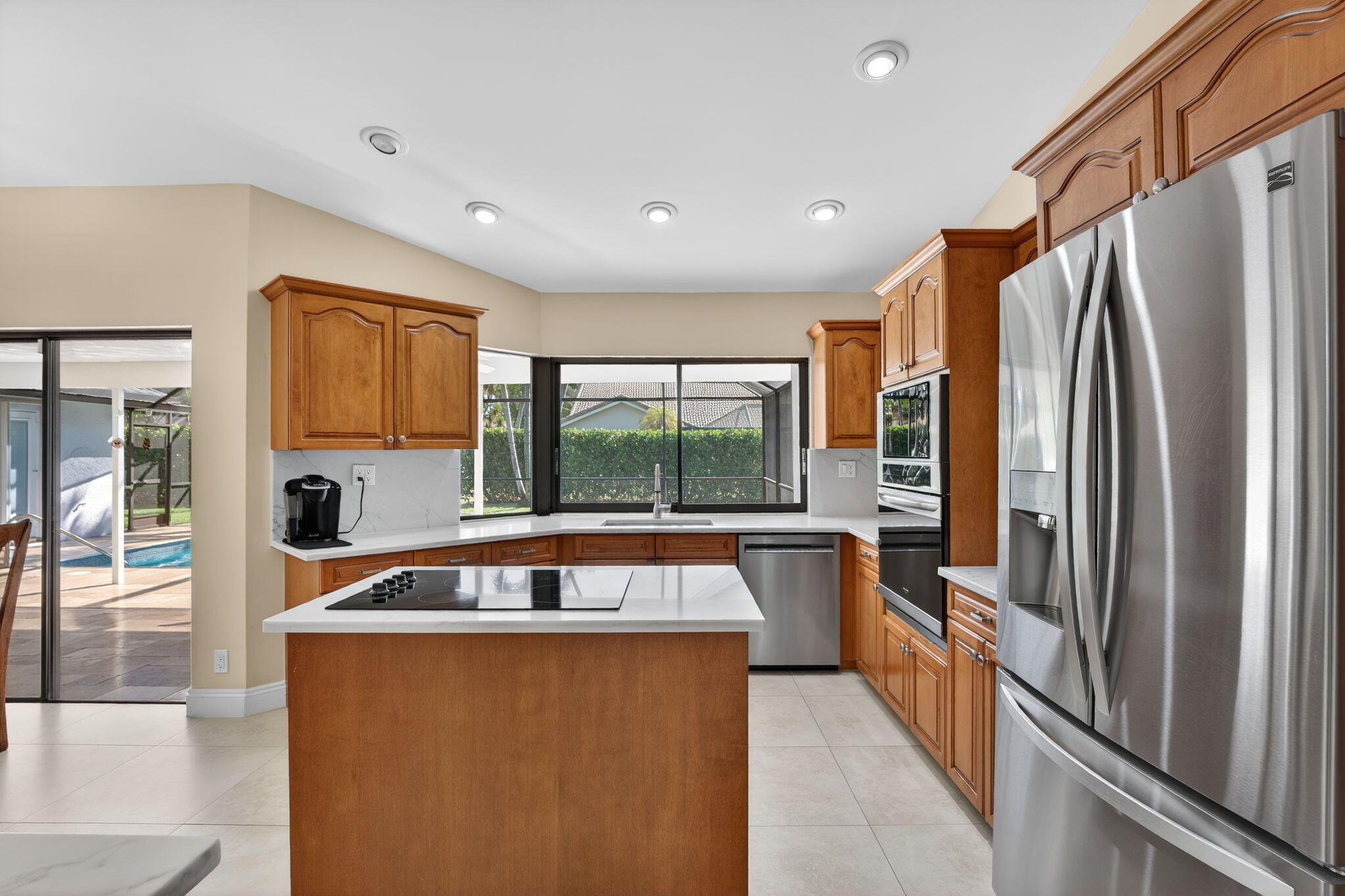 5111 Northwest 85th Road Coral Springs, FL 33067 - Photo 17 of 47 a large kitchen with stainless steel appliances granite countertop a refrigerator and a stove