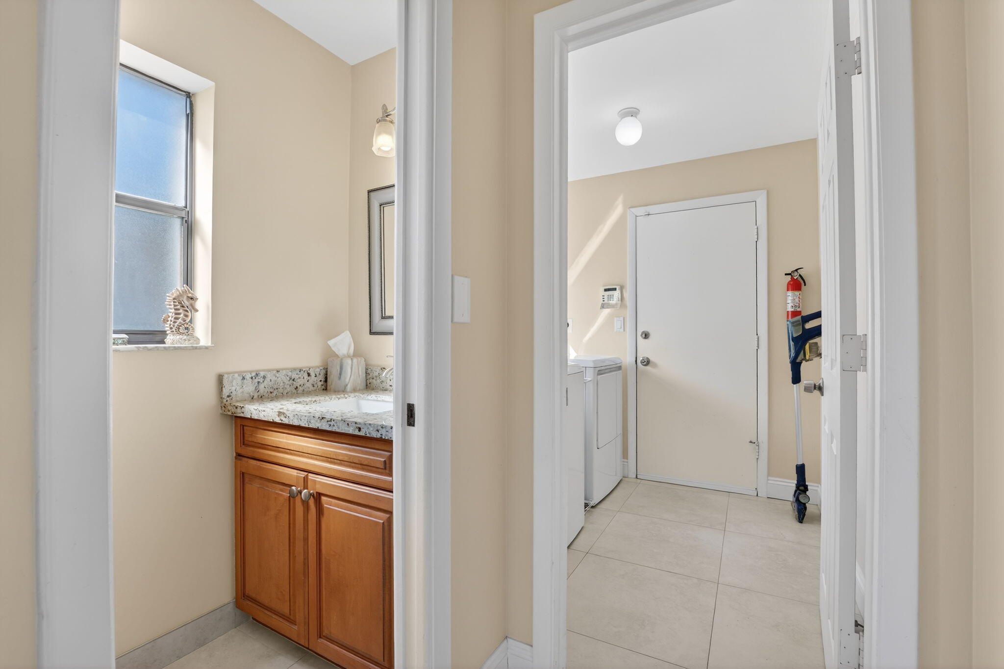 5111 Northwest 85th Road Coral Springs, FL 33067 - Photo 19 of 47 a bathroom with a granite countertop sink and a mirror