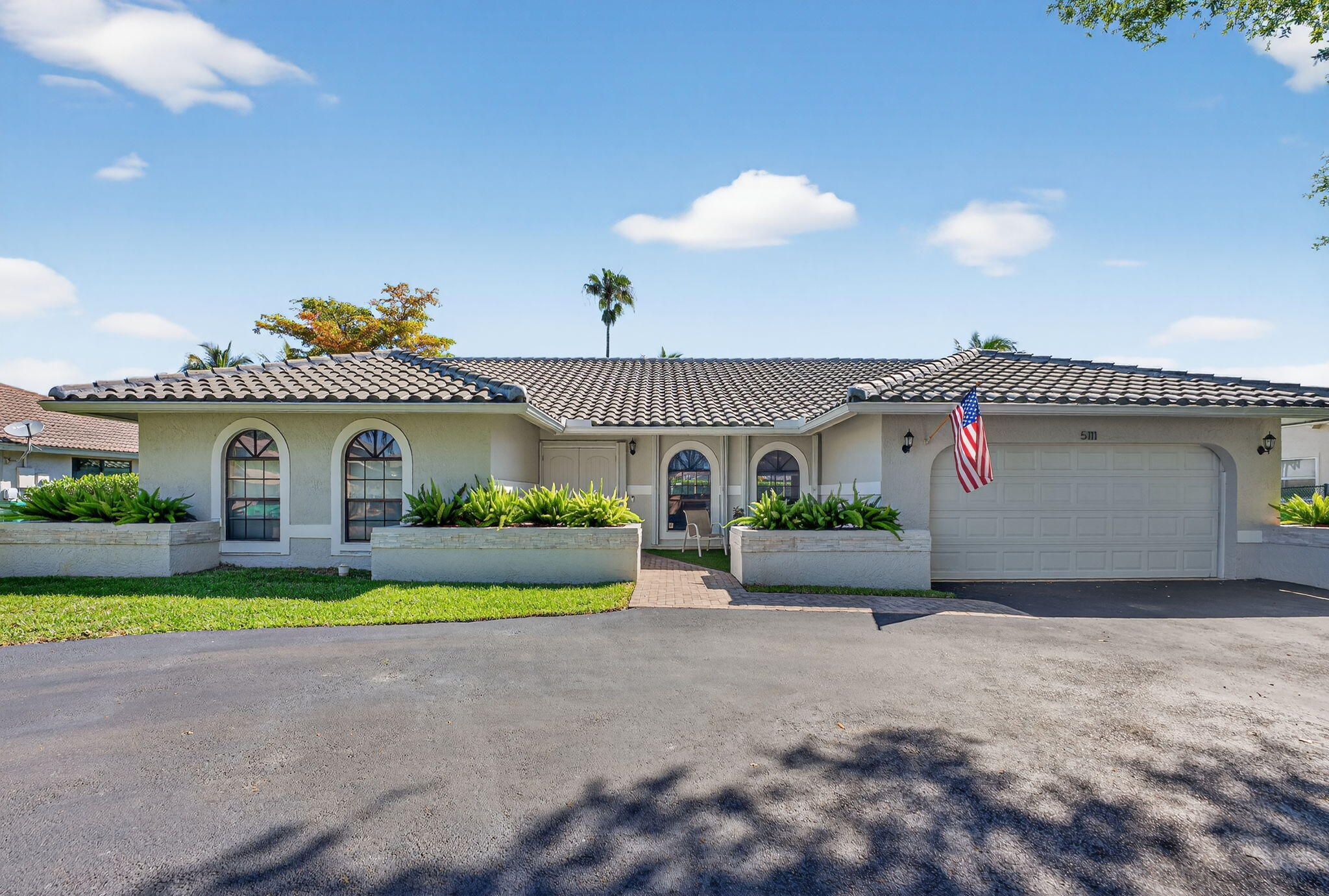 5111 Northwest 85th Road Coral Springs, FL 33067 - Photo 2 of 47 a front view of house with yard and green space
