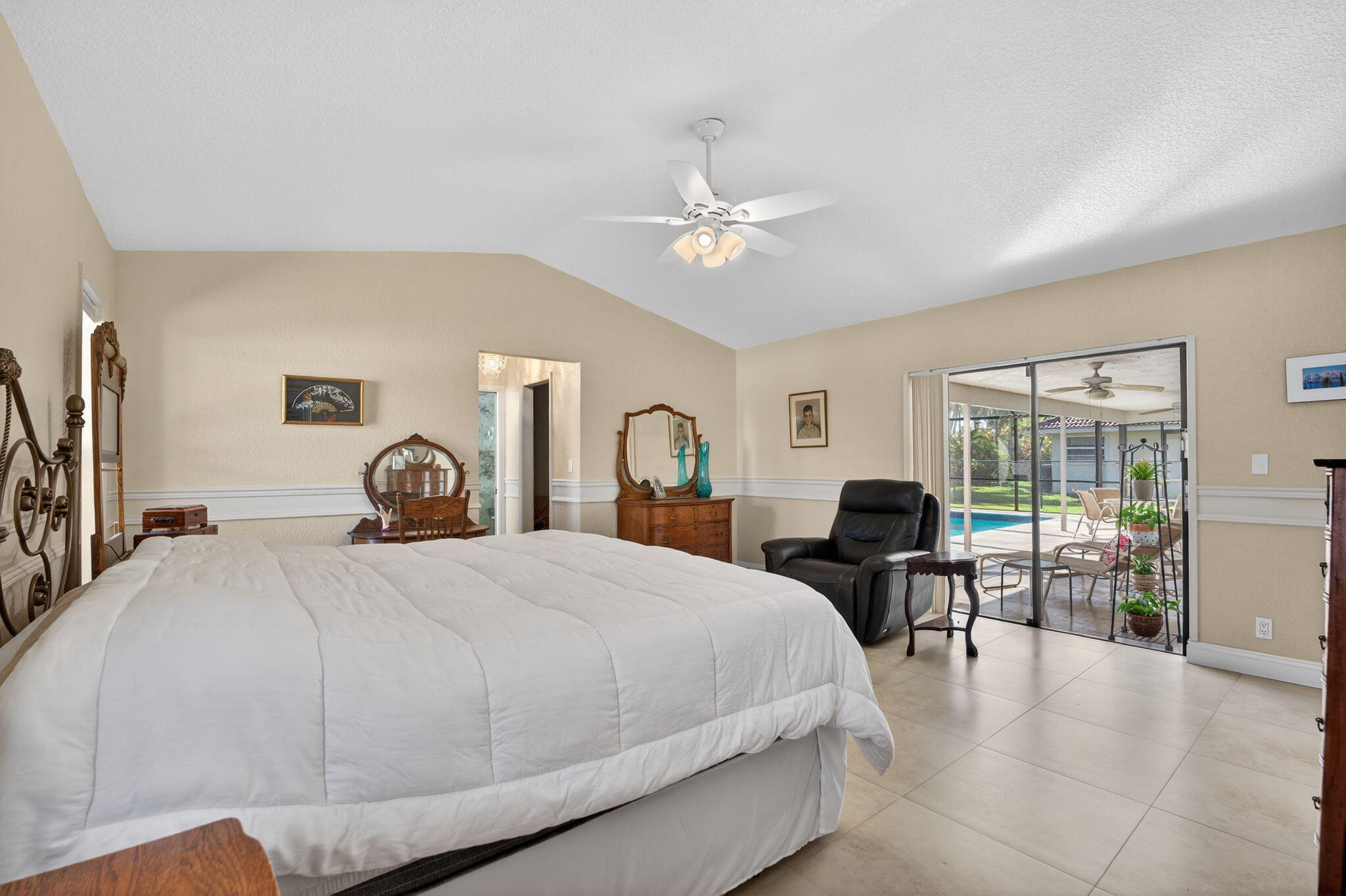 5111 Northwest 85th Road Coral Springs, FL 33067 - Photo 22 of 47 a bedroom with a bed a table and chairs with wooden floor