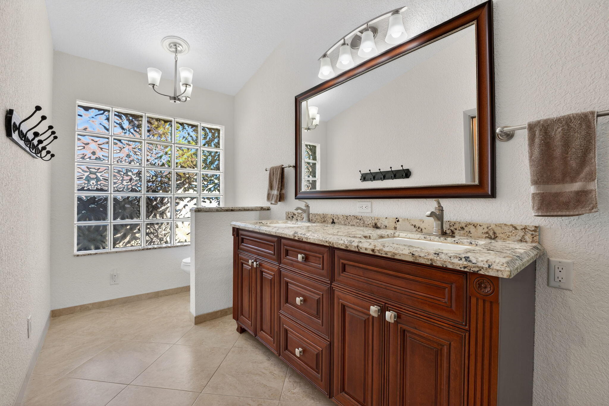 5111 Northwest 85th Road Coral Springs, FL 33067 - Photo 25 of 47 a bathroom with a granite countertop double vanity sink and a mirror