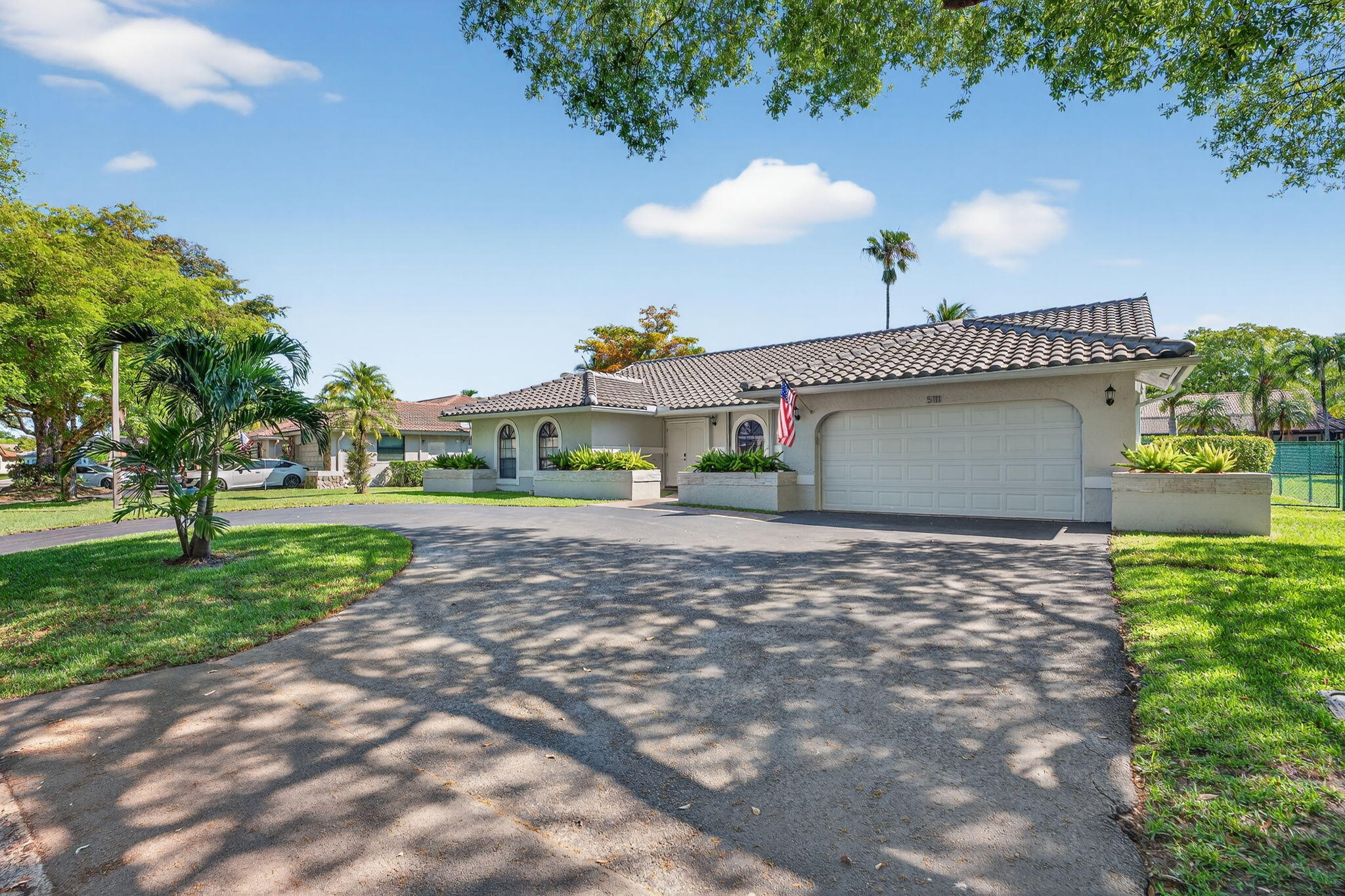 5111 Northwest 85th Road Coral Springs, FL 33067 - Photo 3 of 47 a view of a house with a yard and a garage