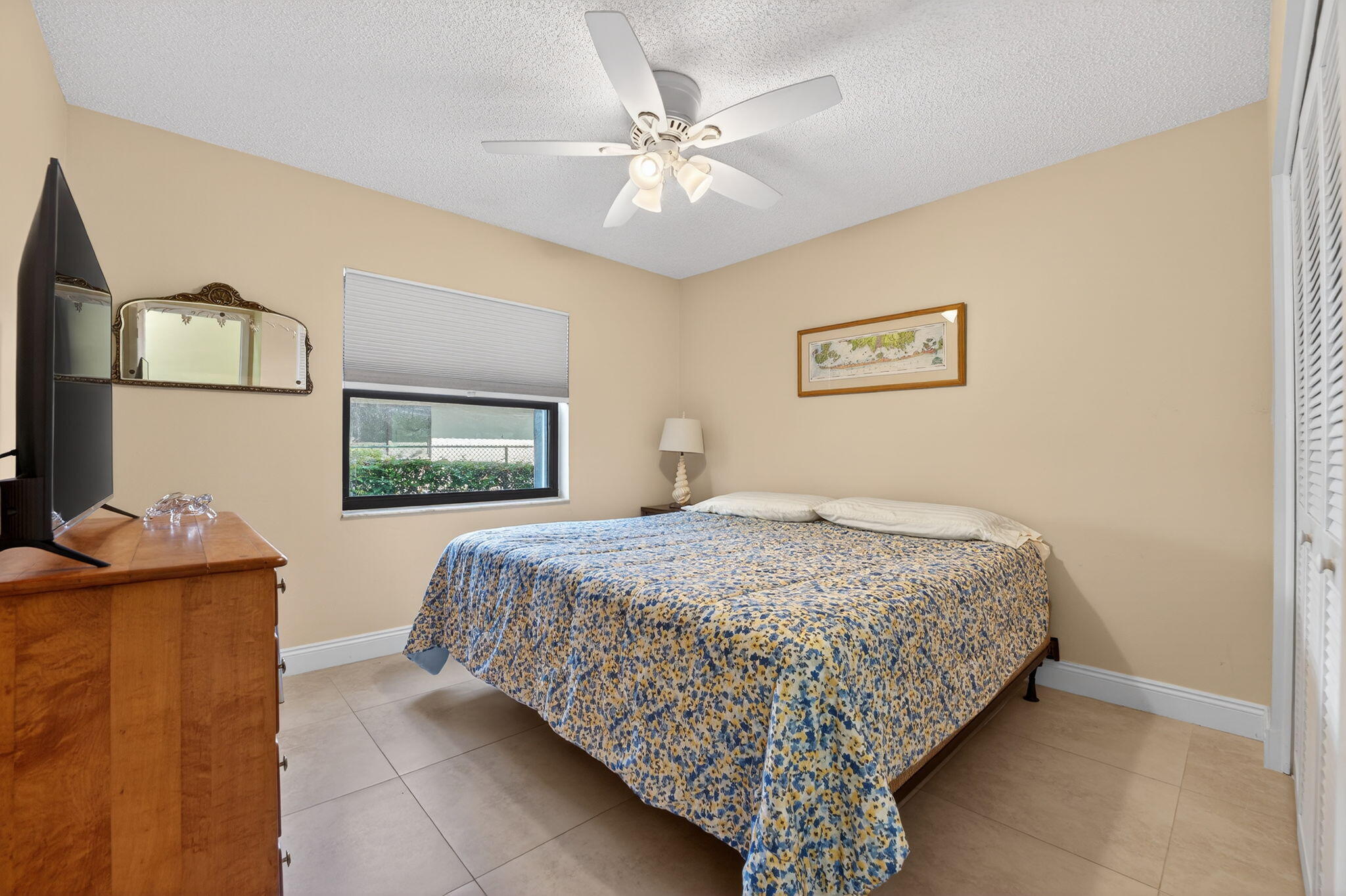 5111 Northwest 85th Road Coral Springs, FL 33067 - Photo 31 of 47 a bedroom with a bed and a chandelier