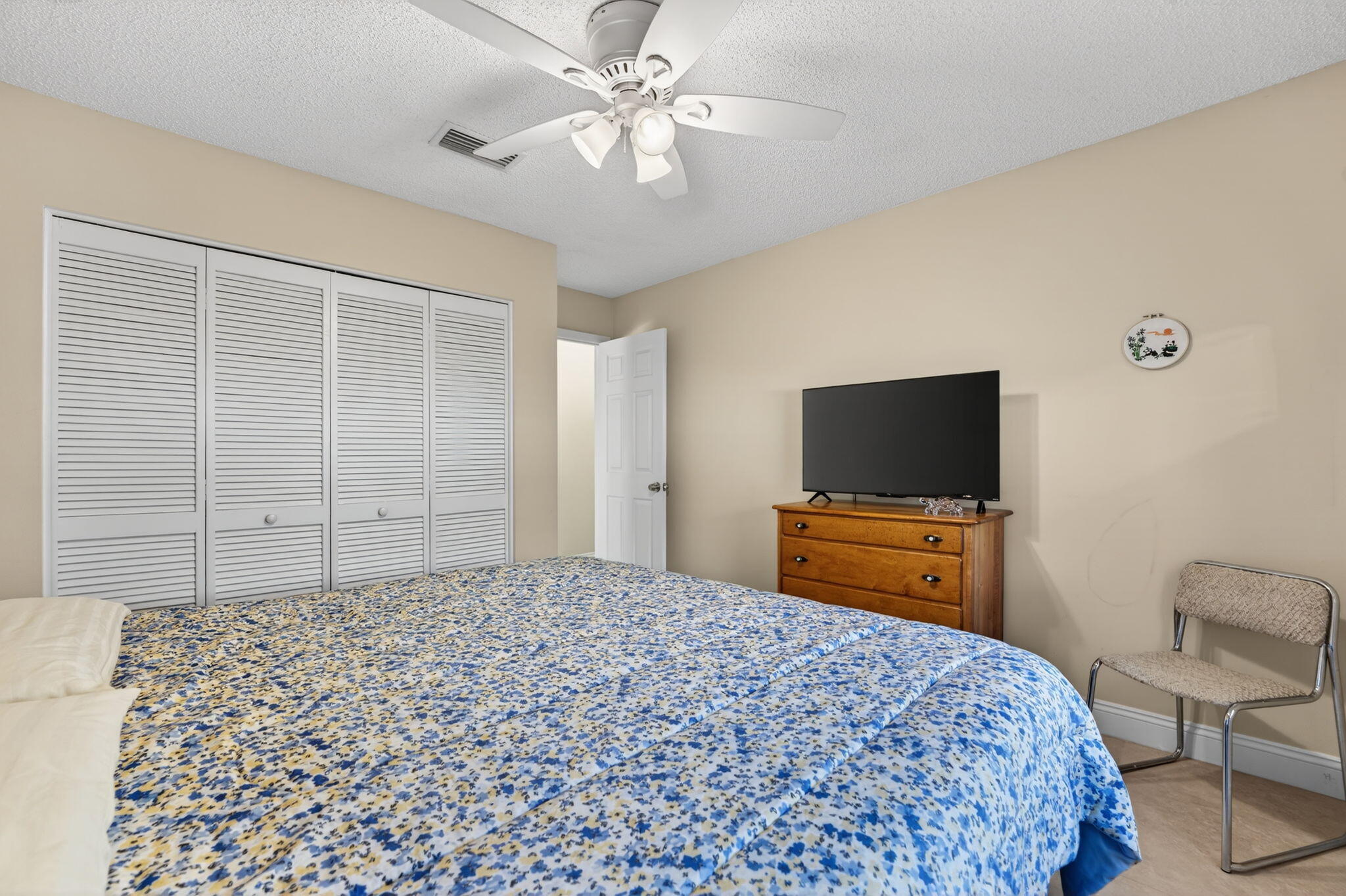 5111 Northwest 85th Road Coral Springs, FL 33067 - Photo 32 of 47 a bedroom with a bed and a flat screen tv