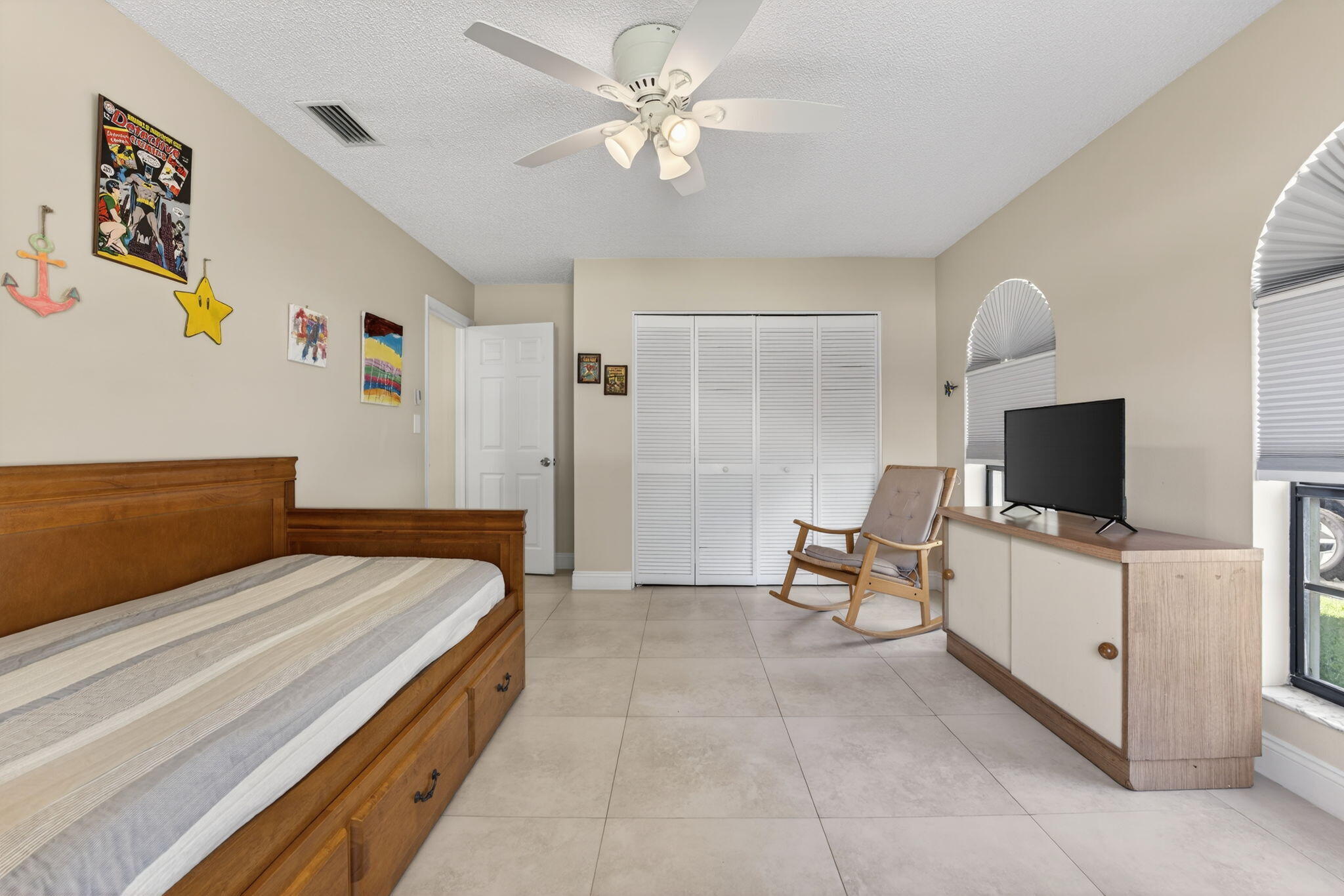 5111 Northwest 85th Road Coral Springs, FL 33067 - Photo 35 of 47 a bedroom with a bed and a flat screen tv