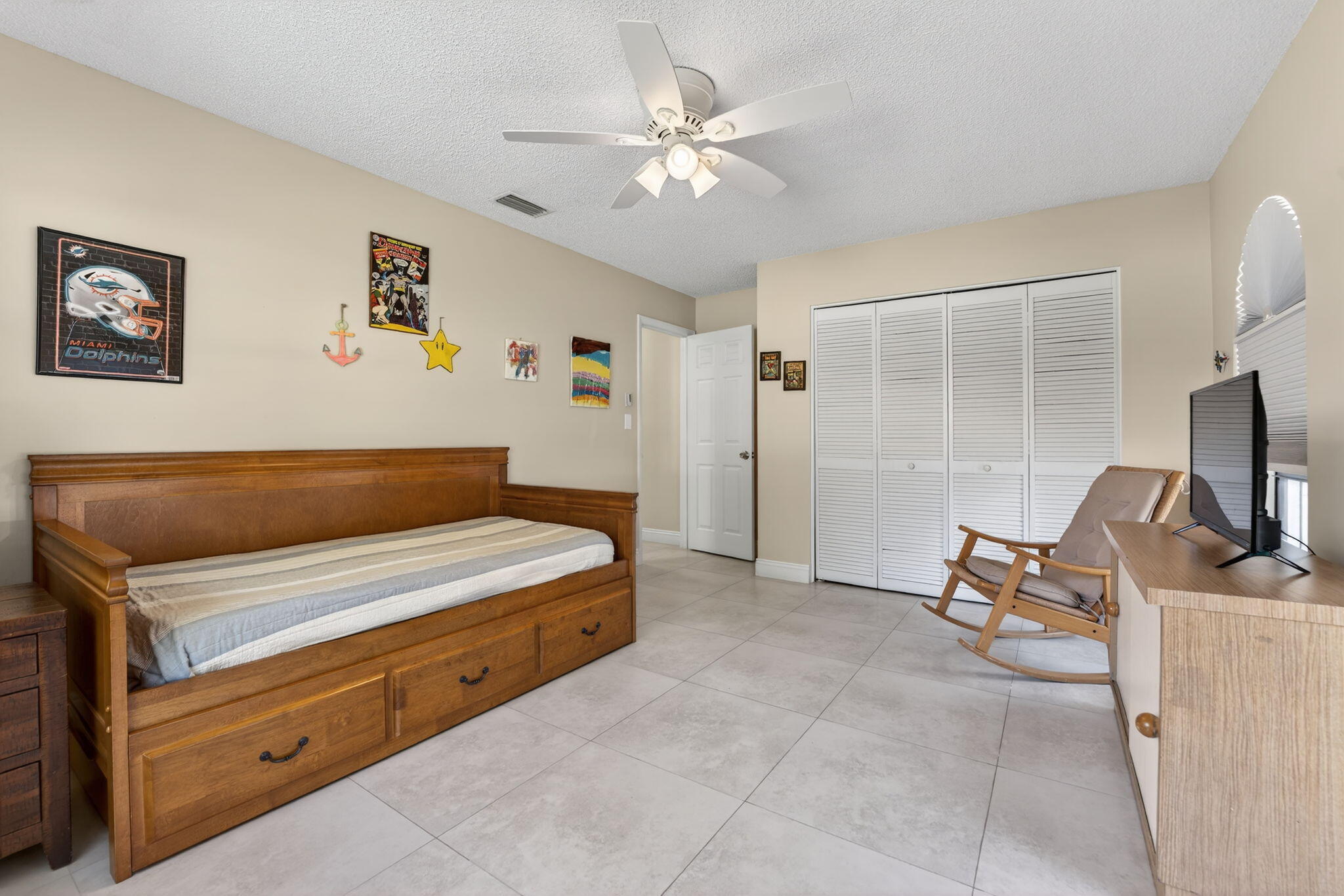 5111 Northwest 85th Road Coral Springs, FL 33067 - Photo 36 of 47 a bedroom with a bed and a chandelier