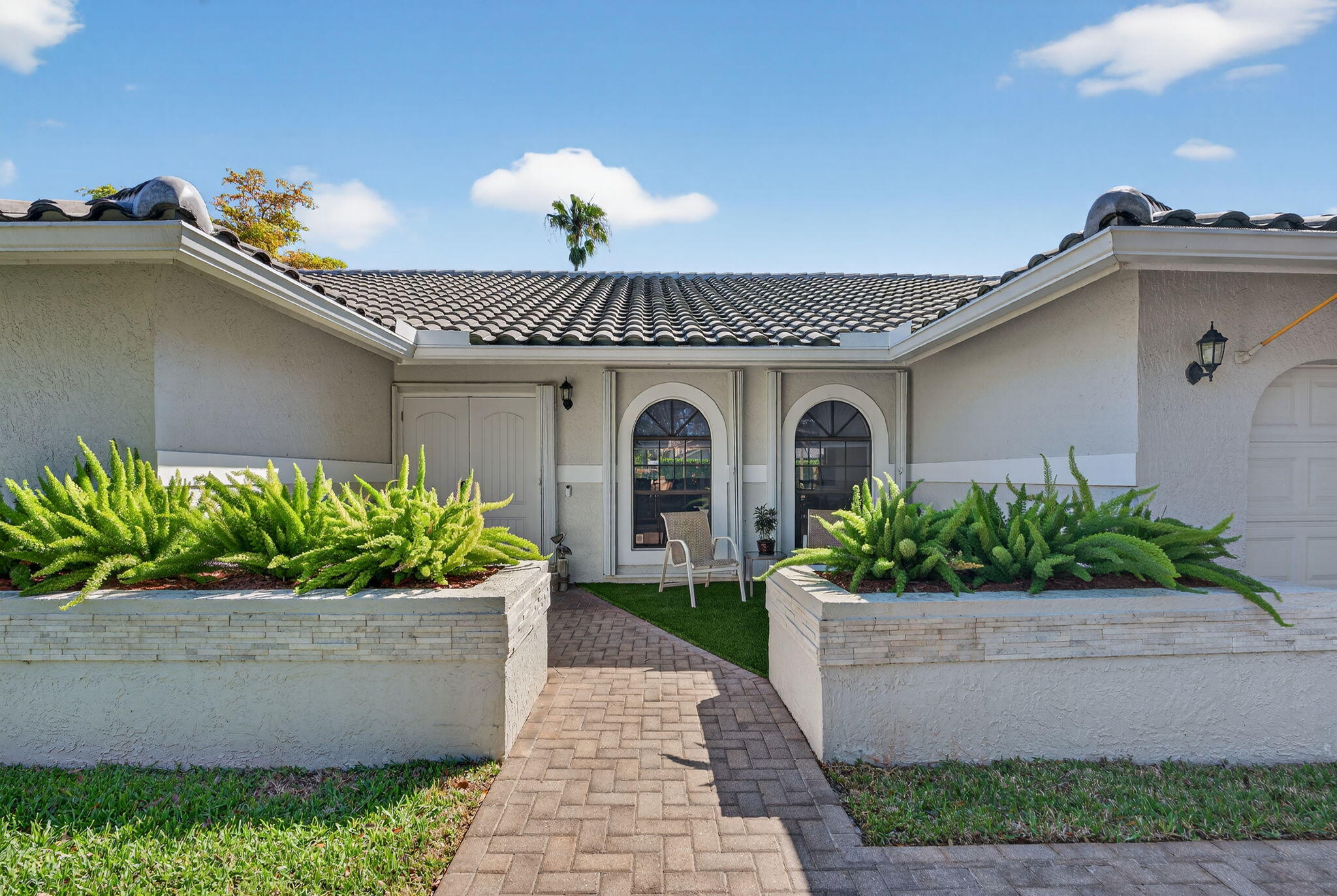 5111 Northwest 85th Road Coral Springs, FL 33067 - Photo 4 of 47 a front view of a house with a garden