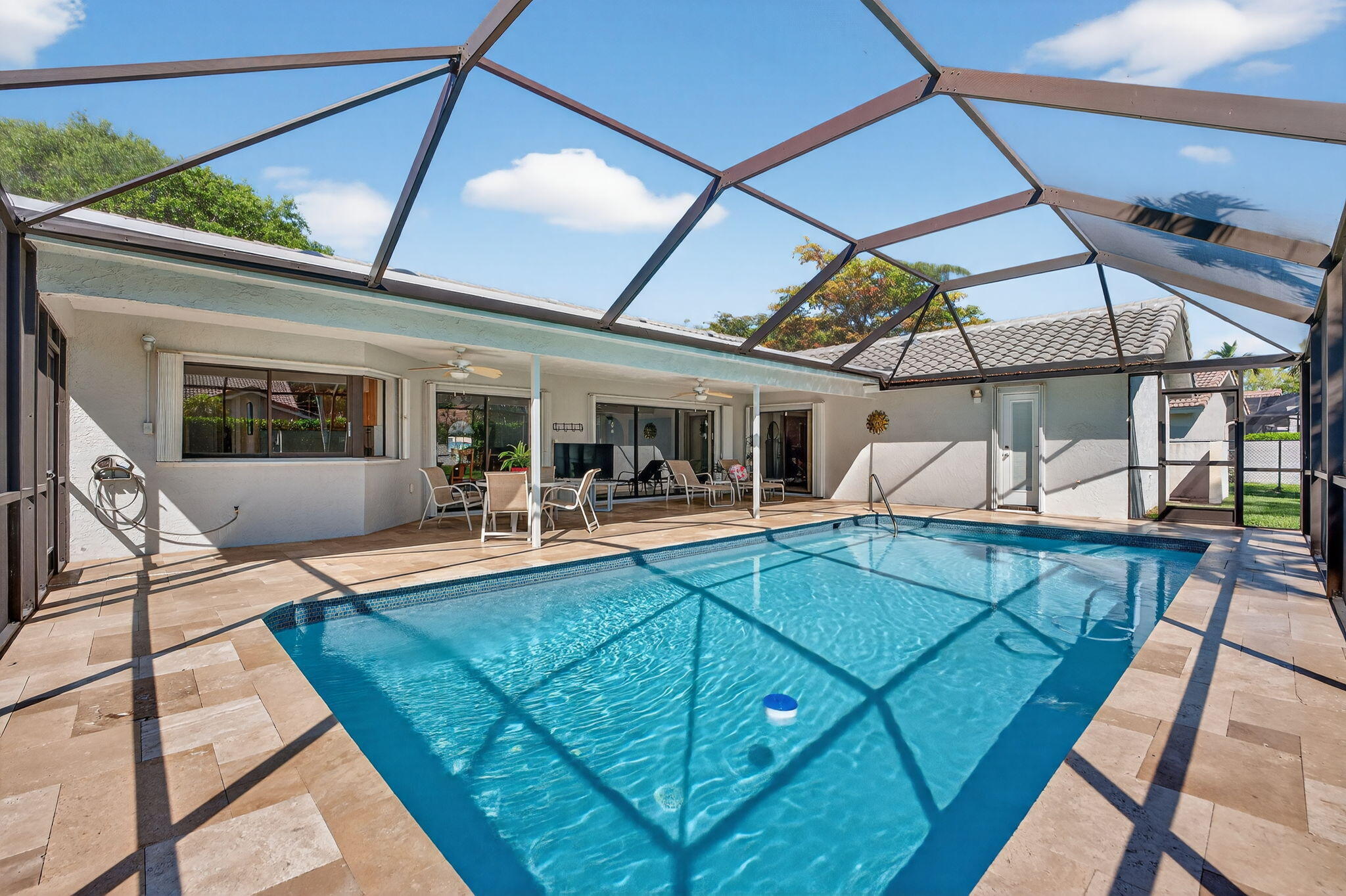 5111 Northwest 85th Road Coral Springs, FL 33067 - Photo 41 of 47 a view of a patio with a table and chairs under an umbrella