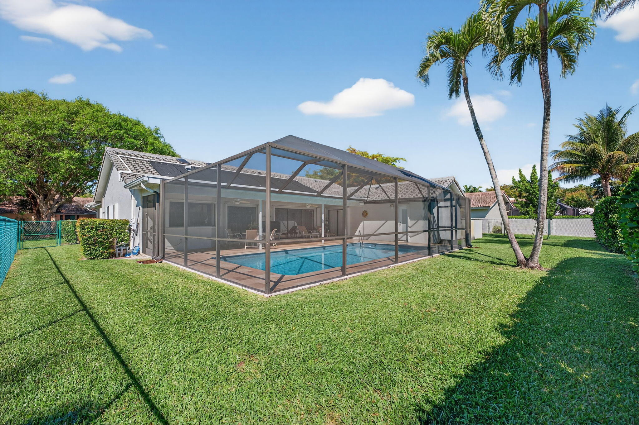 5111 Northwest 85th Road Coral Springs, FL 33067 - Photo 46 of 47 a view of a house with a backyard and a patio