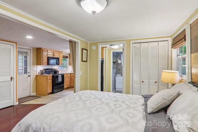 a bedroom with a bed and wooden floor