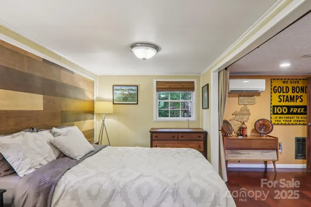a bedroom with a bed and glass windows