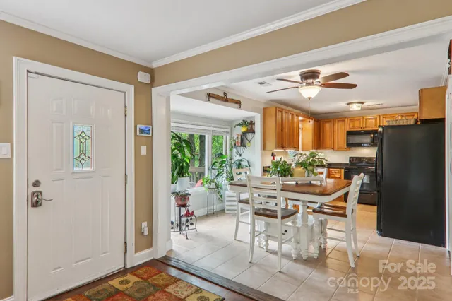 a dining room with furniture and a window