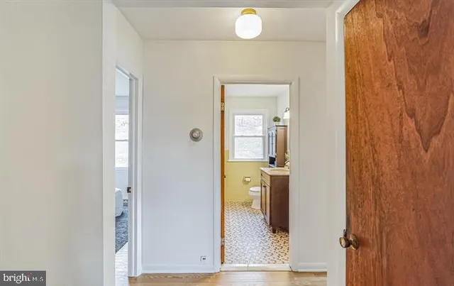 a bathroom with a sink vanity mirror and toilet