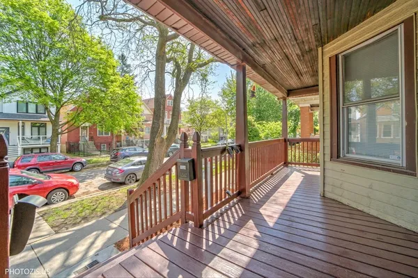 a view of a porch with wooden floor and furniture
