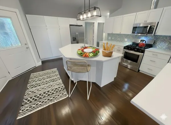 a kitchen with granite countertop a dining table chairs and granite counter tops