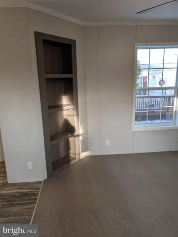 a view of empty room with a fireplace and wooden floor
