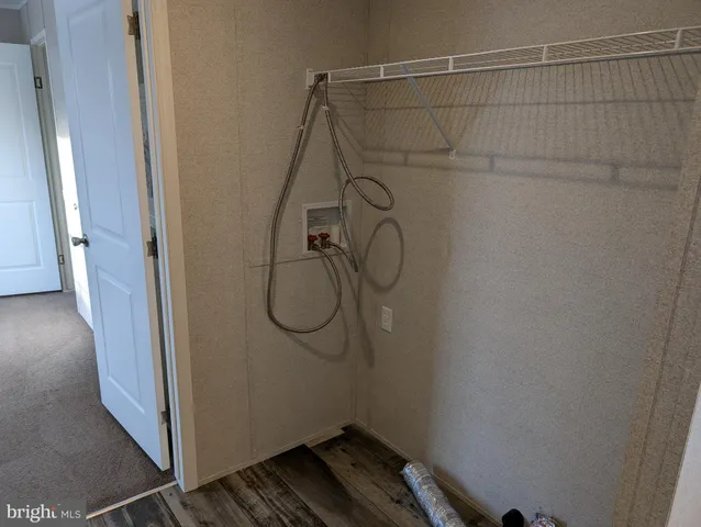 a bathroom that has a shower on the wall