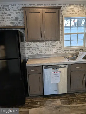 a view of granite countertop white cabinets and sink