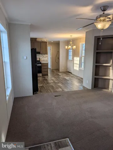 a view of an empty room with a kitchen