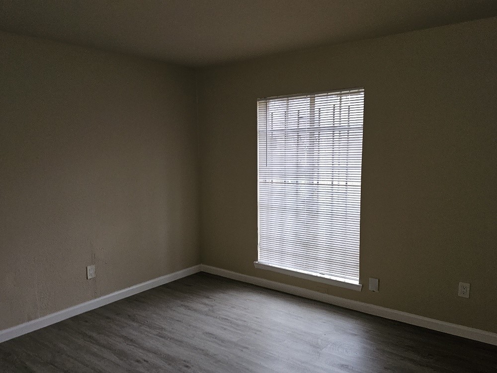 6815 Beachwood Street, Unit 3 Houston, TX 77021 - Photo 16 of 16 a view of an empty room with wooden floor and a window