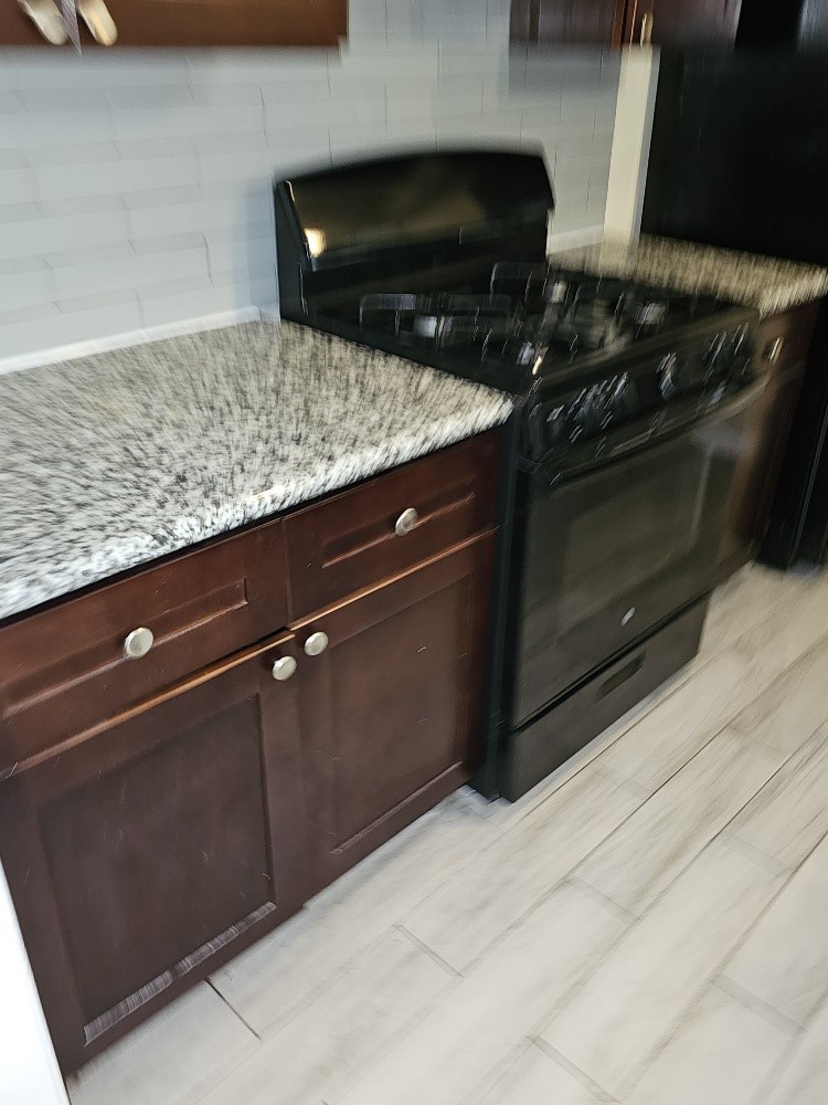 6815 Beachwood Street, Unit 3 Houston, TX 77021 - Photo 2 of 16 a kitchen with a stove and a microwave