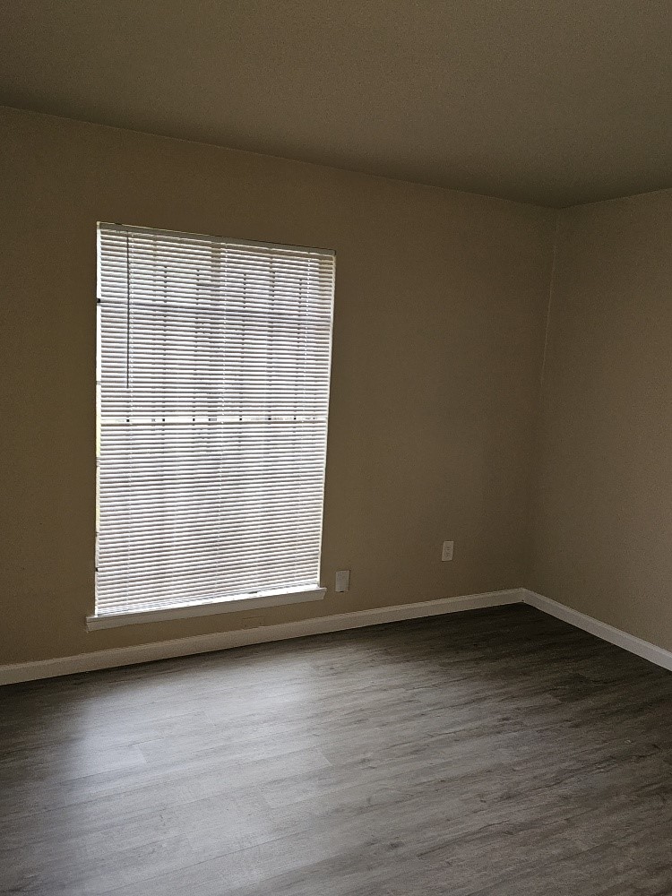 6815 Beachwood Street, Unit 3 Houston, TX 77021 - Photo 7 of 16 a view of wooden floor and brick walls