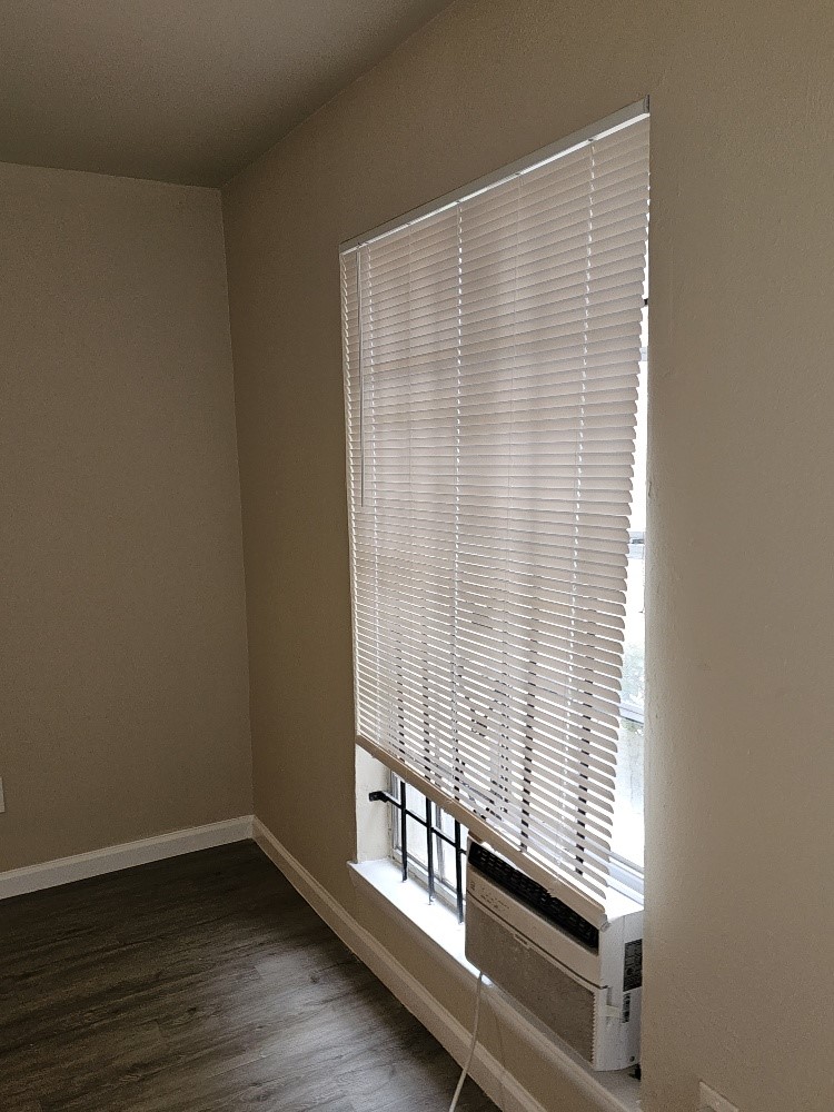 6815 Beachwood Street, Unit 3 Houston, TX 77021 - Photo 8 of 16 a view of an empty room with wooden floor and a window