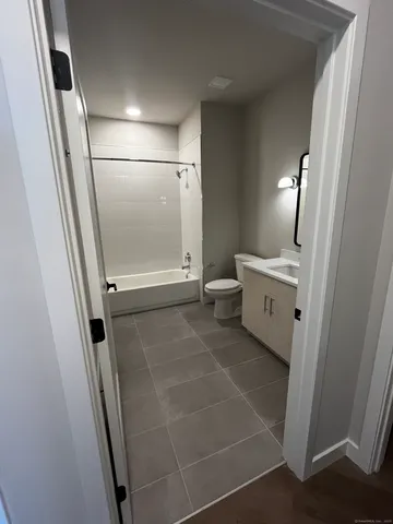 a bathroom with a mirror and a shower