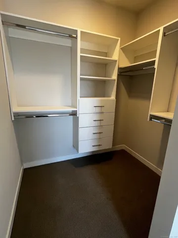 a view of an empty room with storage