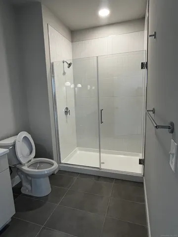 a bathroom with a toilet and a shower