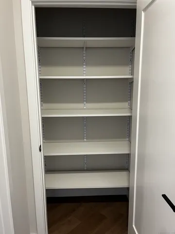 a view of walk in closet with empty racks