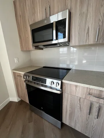 a kitchen with a stove and a microwave
