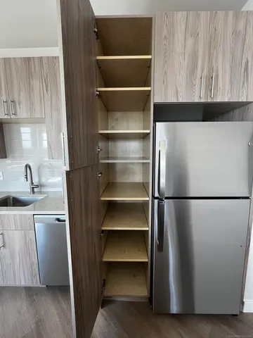 a view of walk in closet with empty racks