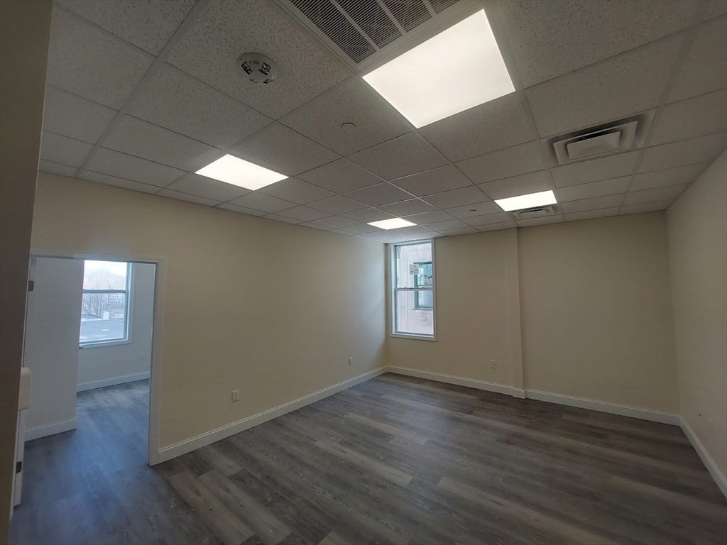 491 Main Street, Unit 11 Athol, MA 01331 - Photo 2 of 10 an empty room with wooden floor and windows