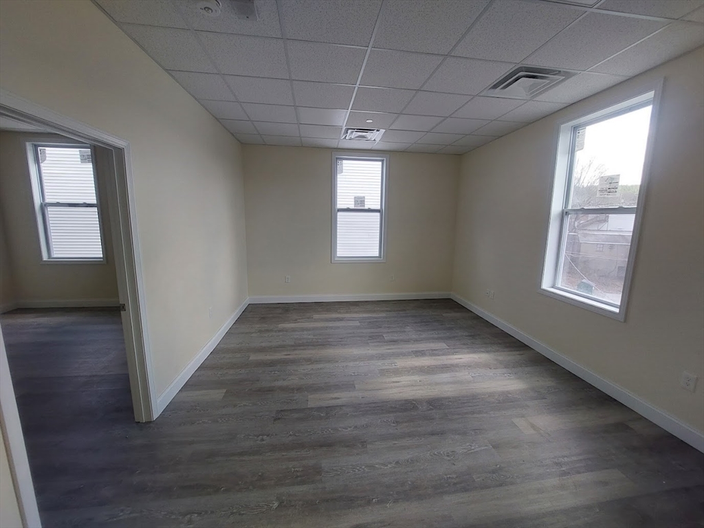 491 Main Street, Unit 11 Athol, MA 01331 - Photo 4 of 10 a view of empty room with wooden floor and fan