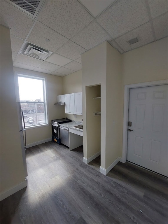 491 Main Street, Unit 11 Athol, MA 01331 - Photo 5 of 10 a view of a kitchen with refrigerator and wooden floor