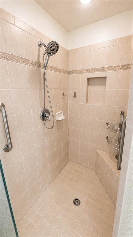 6552 Moorings Point Circle, Unit 102 Lakewood Ranch, FL 34202 - Photo 21 of 57 a bathroom with a bath tub with a shower