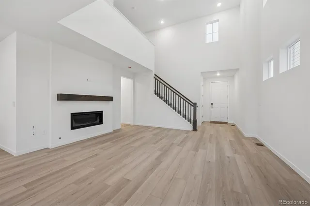 a view of a livingroom with wooden floor and a fireplace