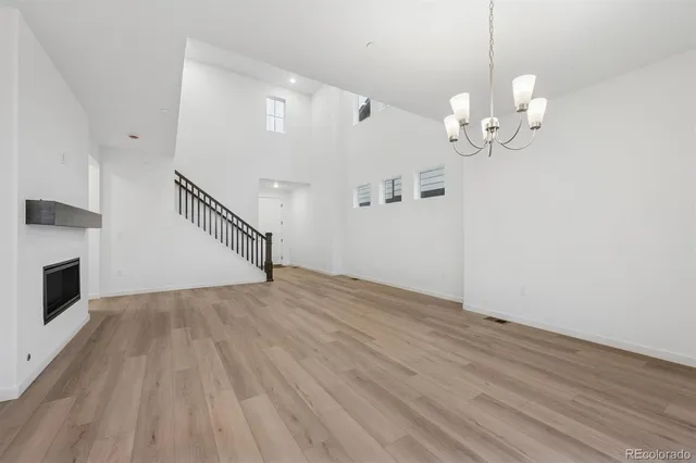 a view of a room with wooden floor and ceiling fan