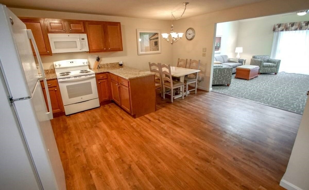 141 Great Neck Road South, Unit 203 Mashpee, MA 02649 - Photo 4 of 16 a kitchen with a sink appliances and cabinets