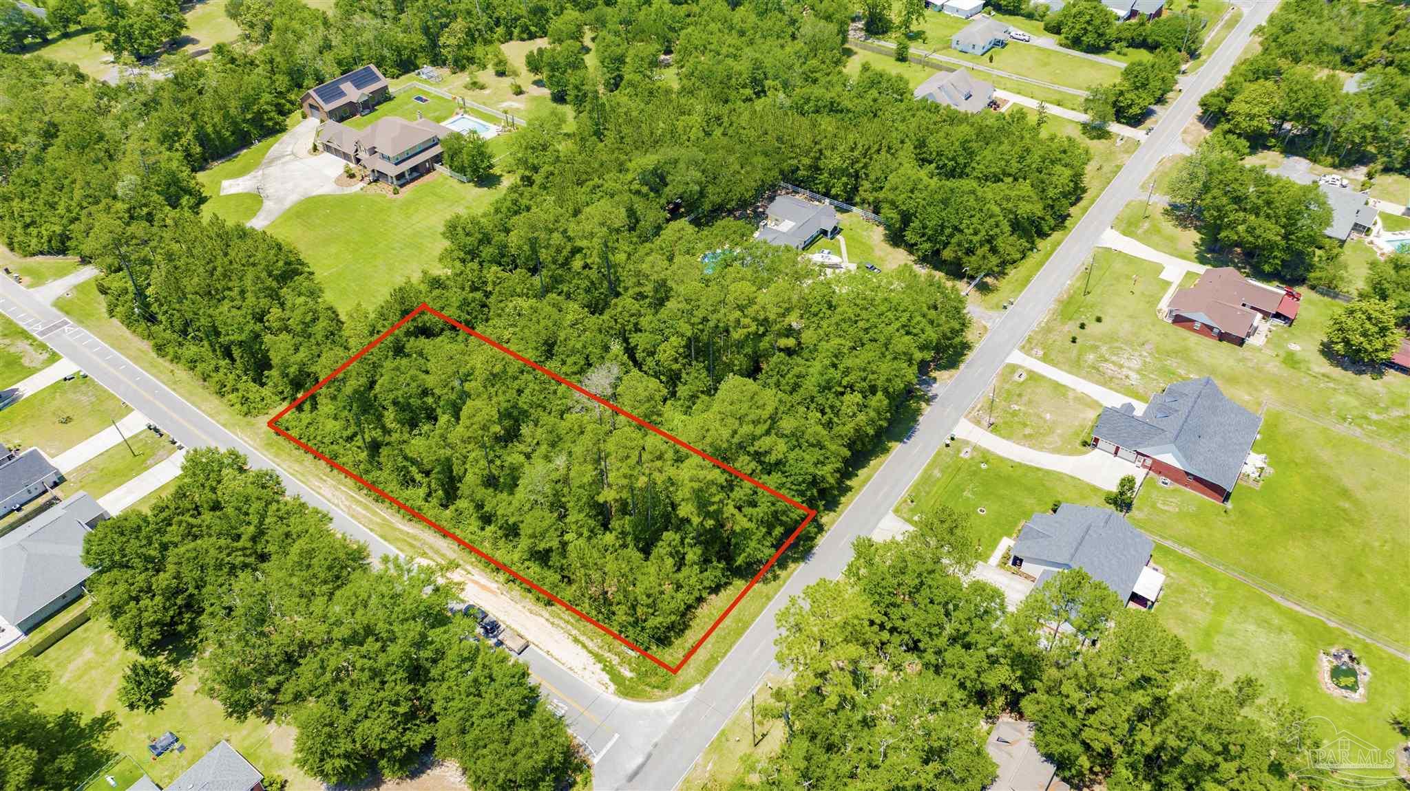 3195 Stefani Road Cantonment, FL 32533 - Photo 4 of 10 an aerial view of a residential houses with yard and swimming pool