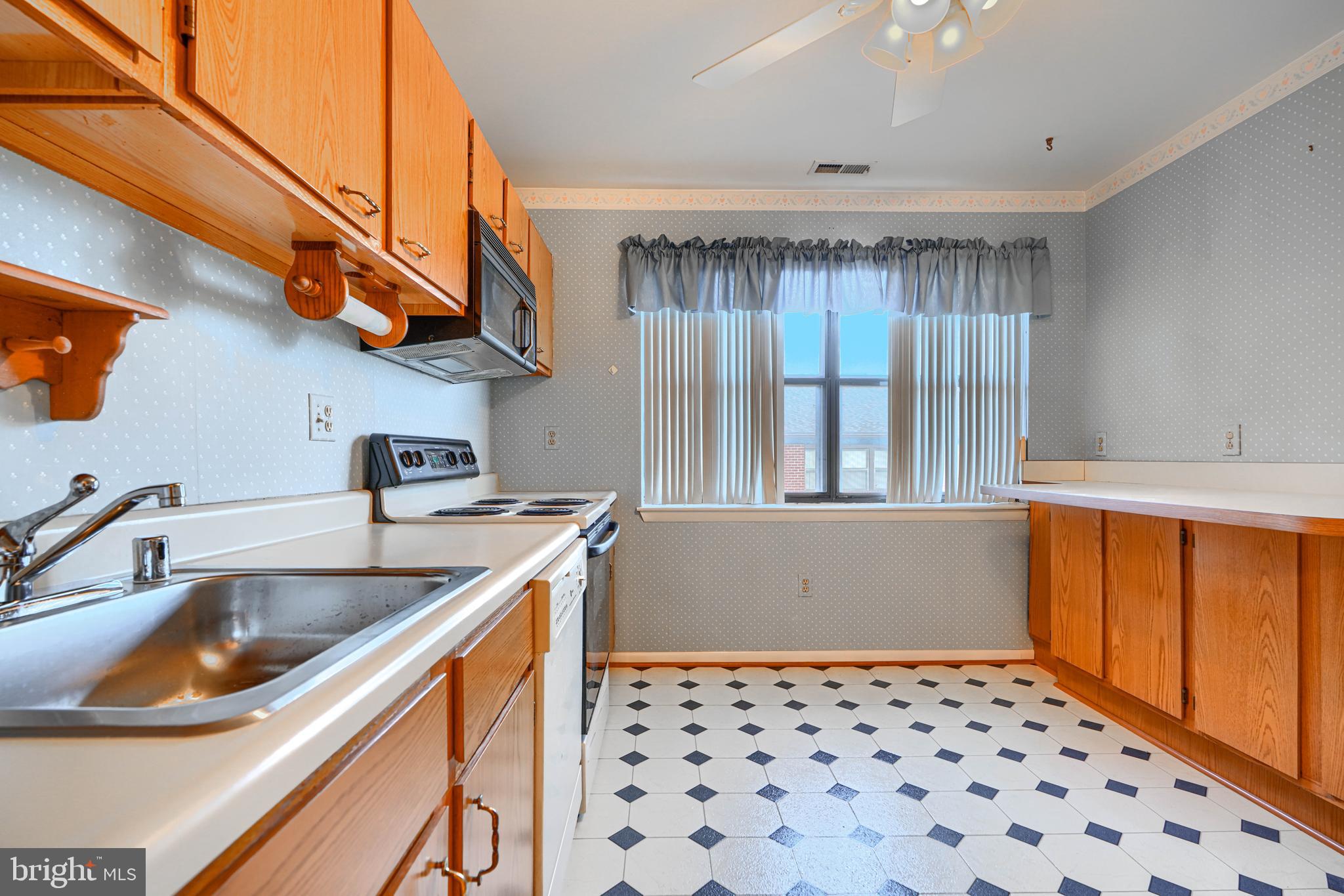 4 Juliet Lane, Unit 301 Baltimore, MD 21236 - Photo 11 of 29 a kitchen with a sink and a refrigerator